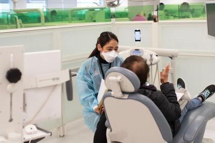 a dental student works with a patient